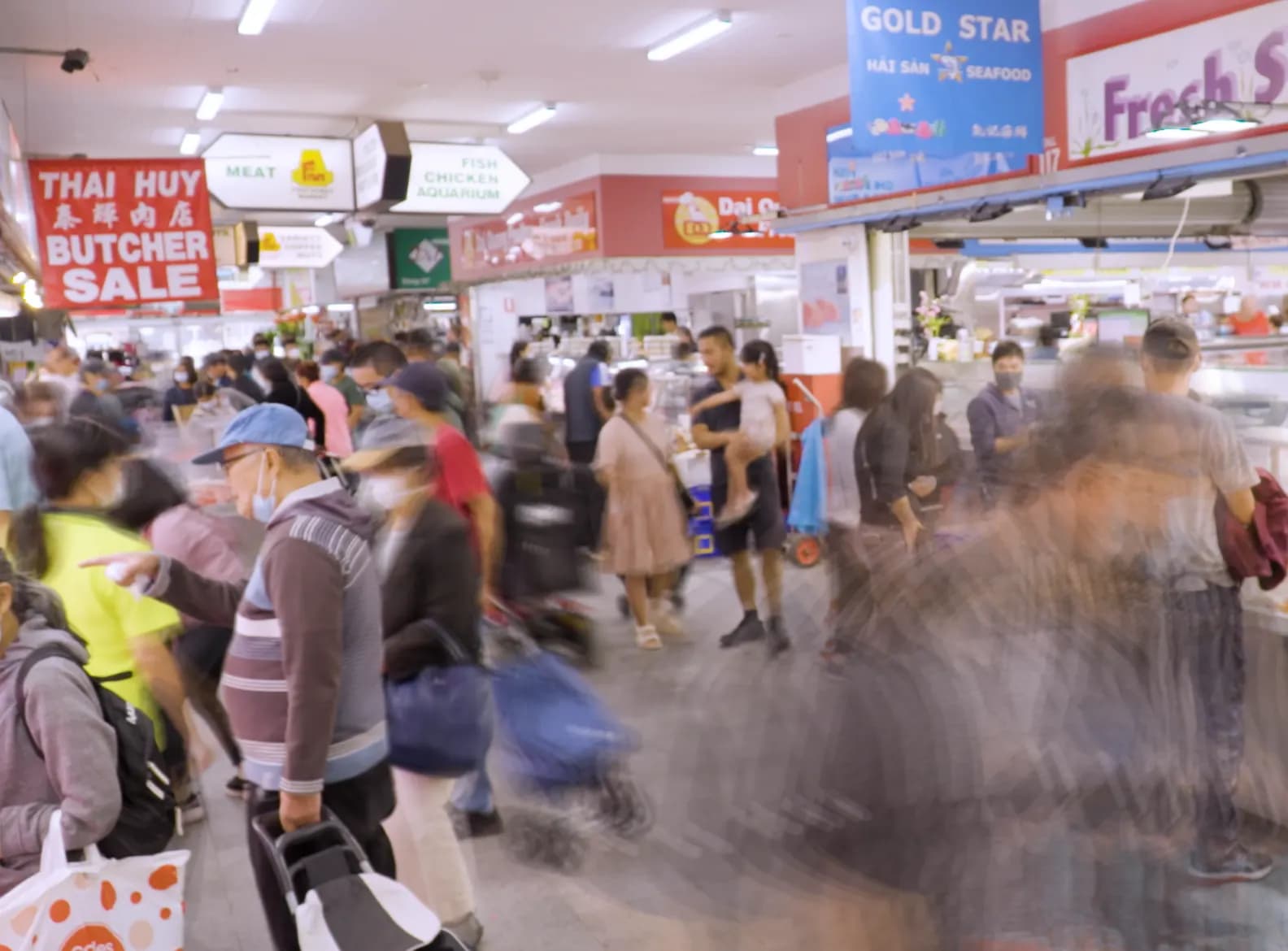 Shoppers in the aisles of Footscray Market