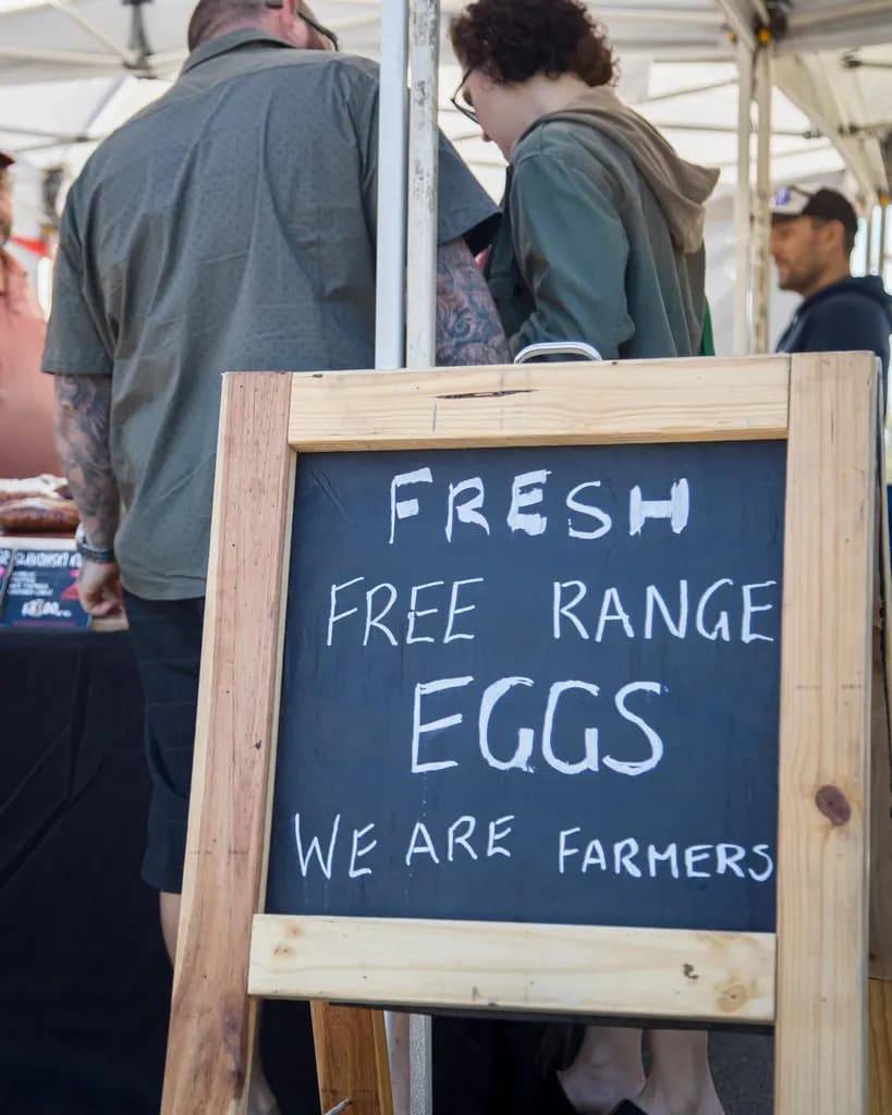 A chalkboard sign for free range eggs at The Carseldine Farmers and Artisan Markets