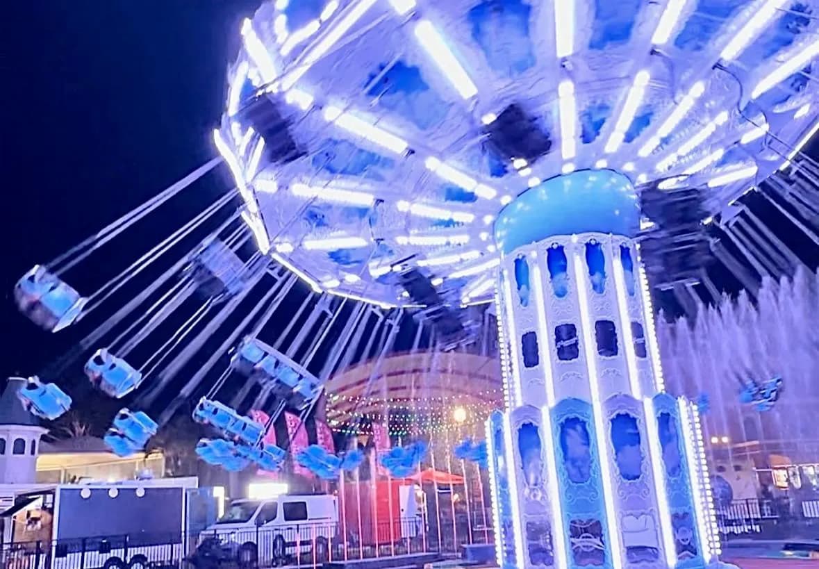A lit swing ride at Dreamworld Night Market after dark