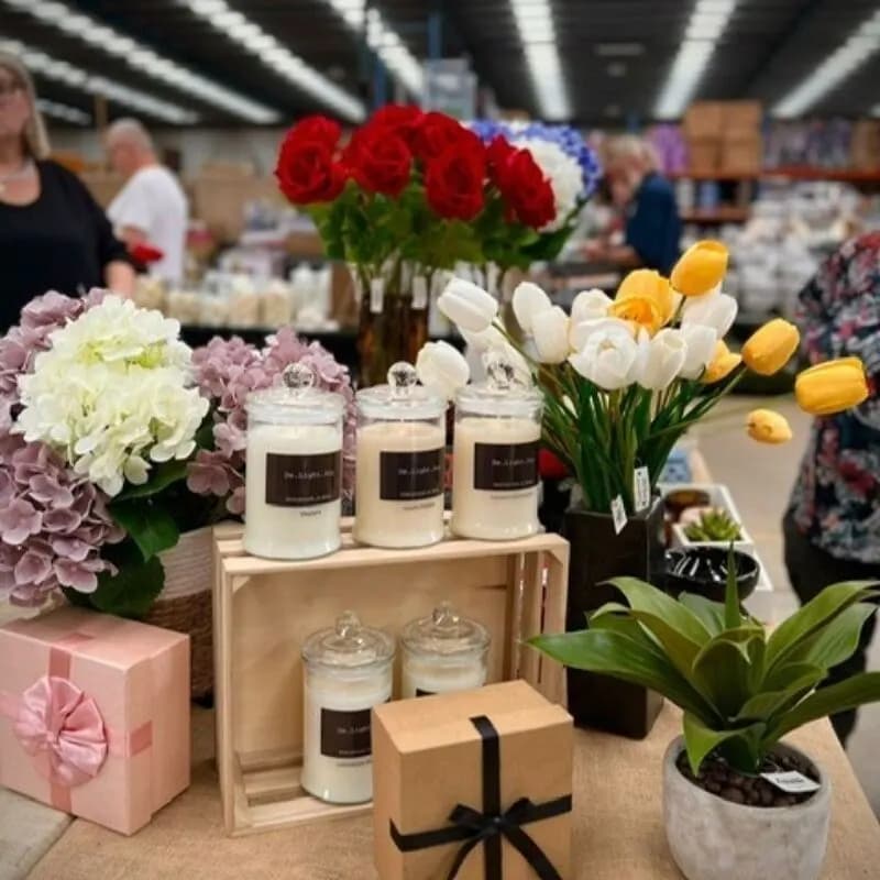 Candles and flowers on a stall inside Laverton Market