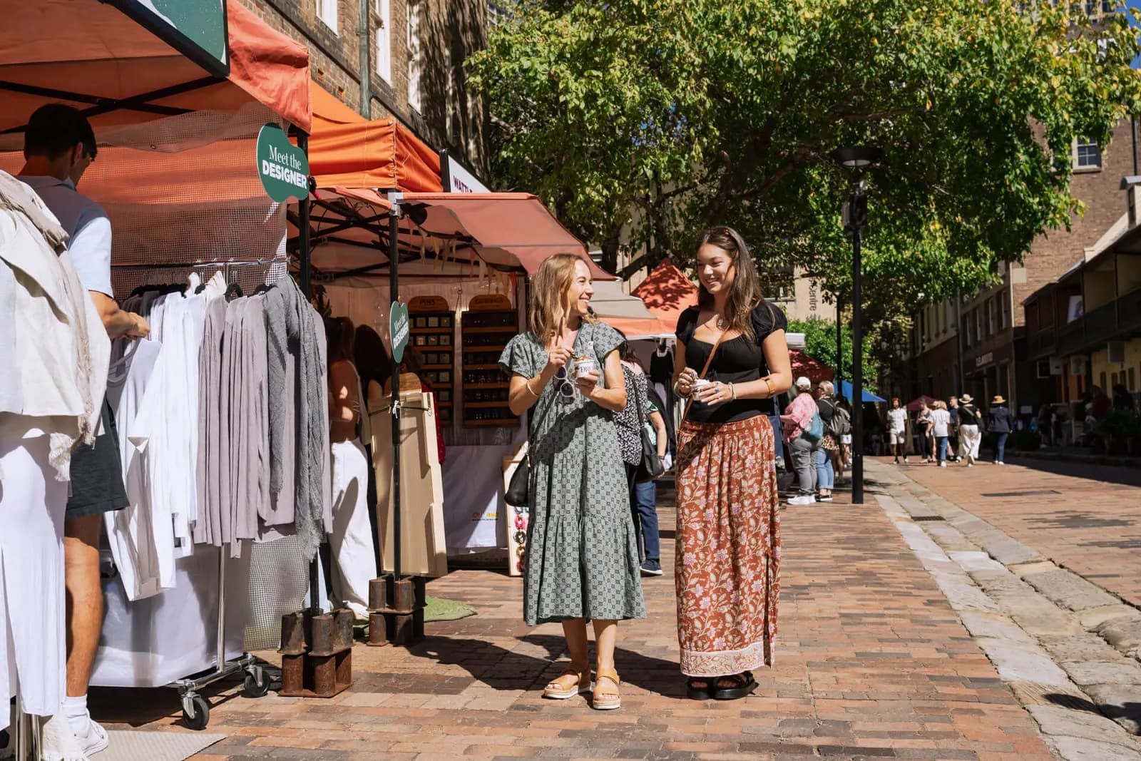 Clothing stalls on the cobbled street at The Rocks Market