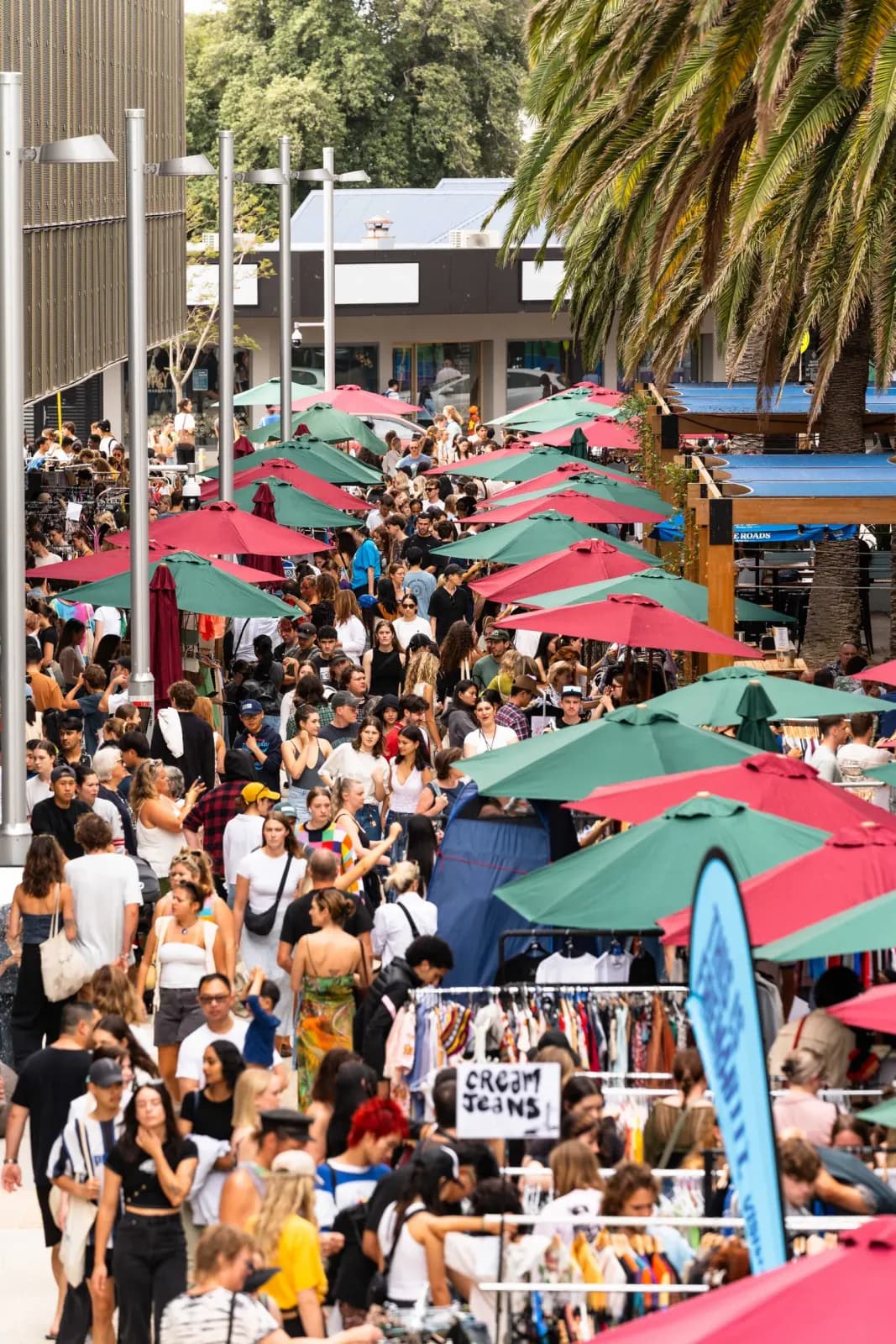 Crowd among the stall umbrellas at the Pre Loved Clothing Market