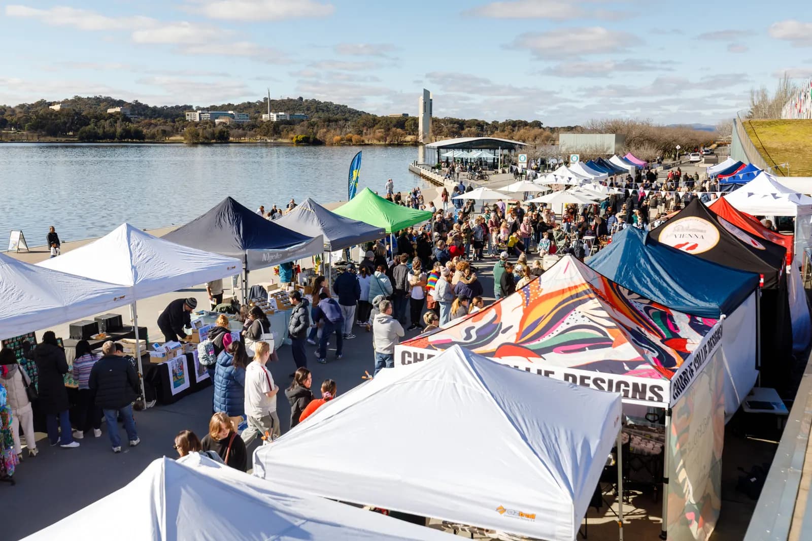 Rows of stalls beside Lake Burley Griffin at The Little Burley Market