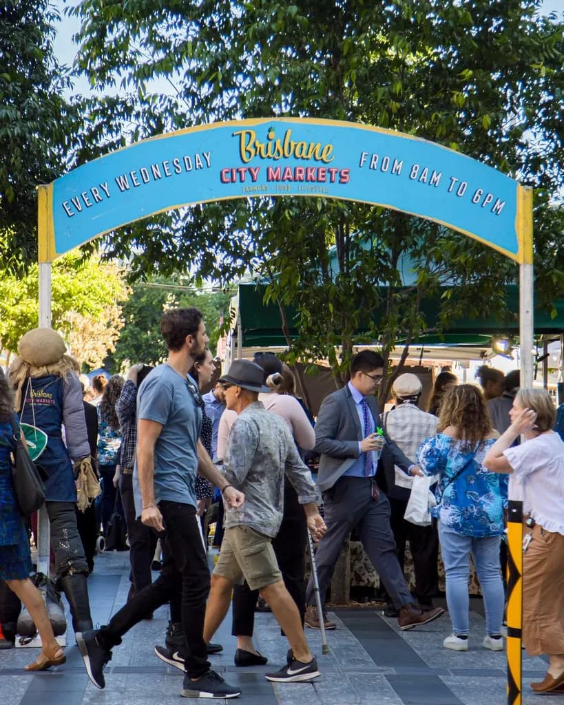 Shoppers under the entrance arch at Brisbane City Markets