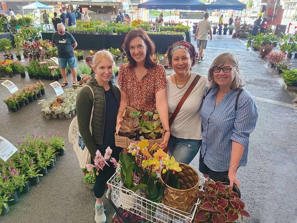 Shoppers with plants in the aisle at Brisbane Markets
