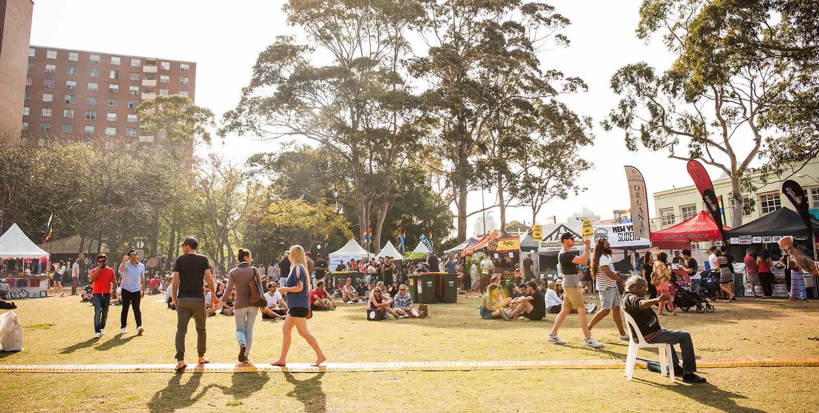 Stalls and visitors in the park at Surry Hills Market