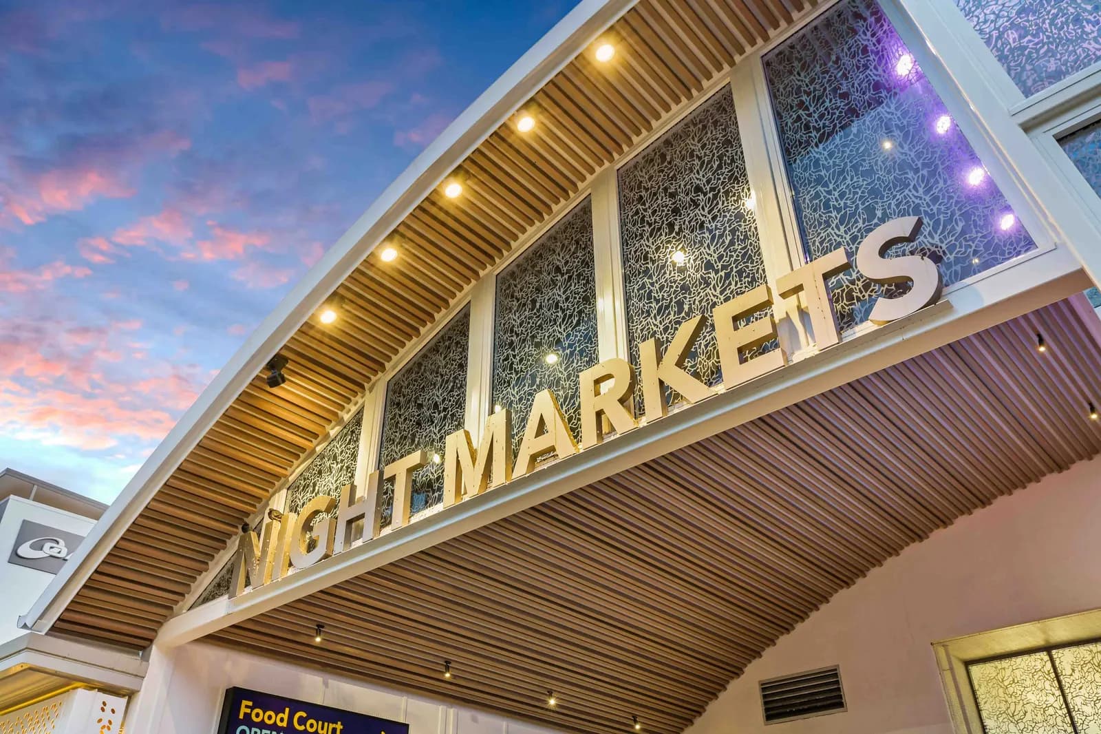 The lit entrance to Cairns Night Markets at dusk