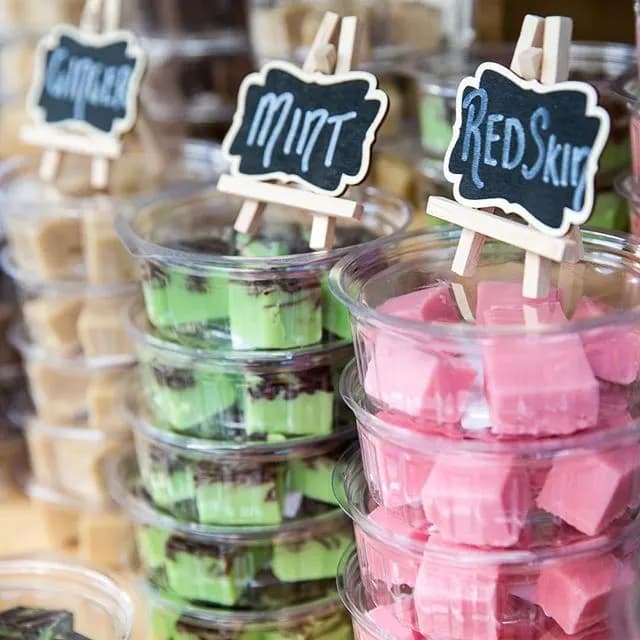 Tubs of fudge with chalkboard labels on a market stall